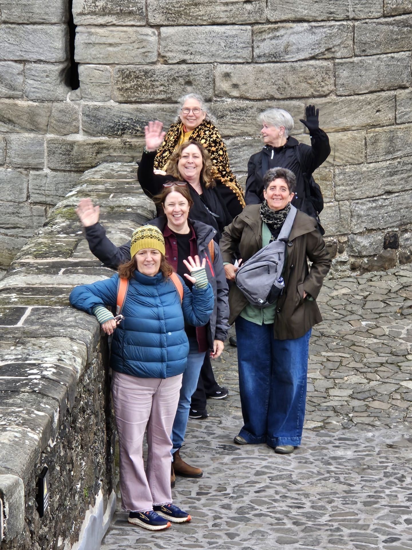 A waving group of six women
