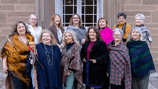 A group of ladies standing in front of a door